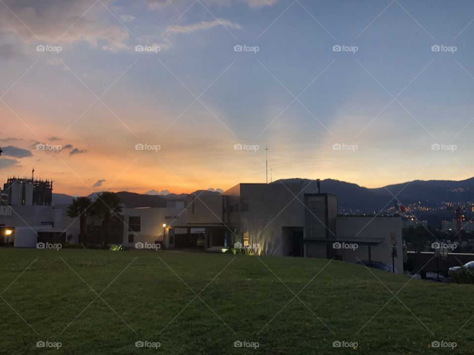 This is a picture from a house in mexico city, where the sun is just right and it looks as if the house had its own light reaching out to the sky