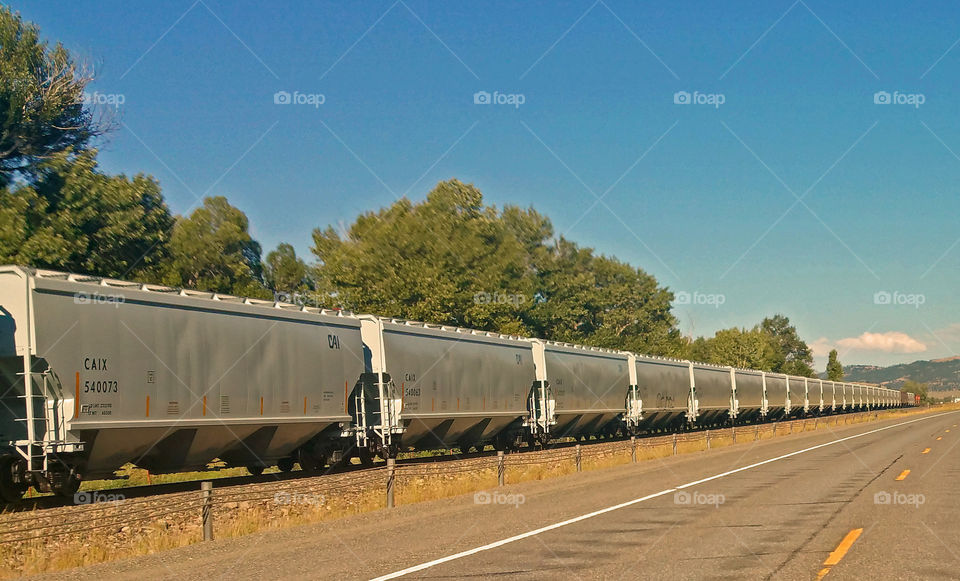 Railroad Cars Being Pulled be Locomotives
