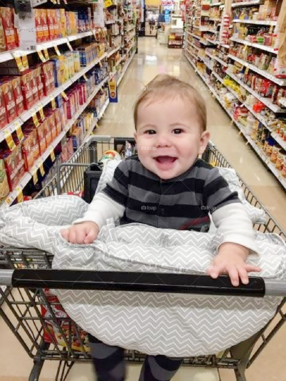 Happy baby eyes light up even   a mundane shopping trip