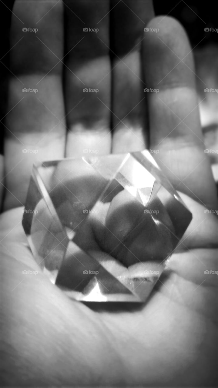 Clear geometric glass in hand.