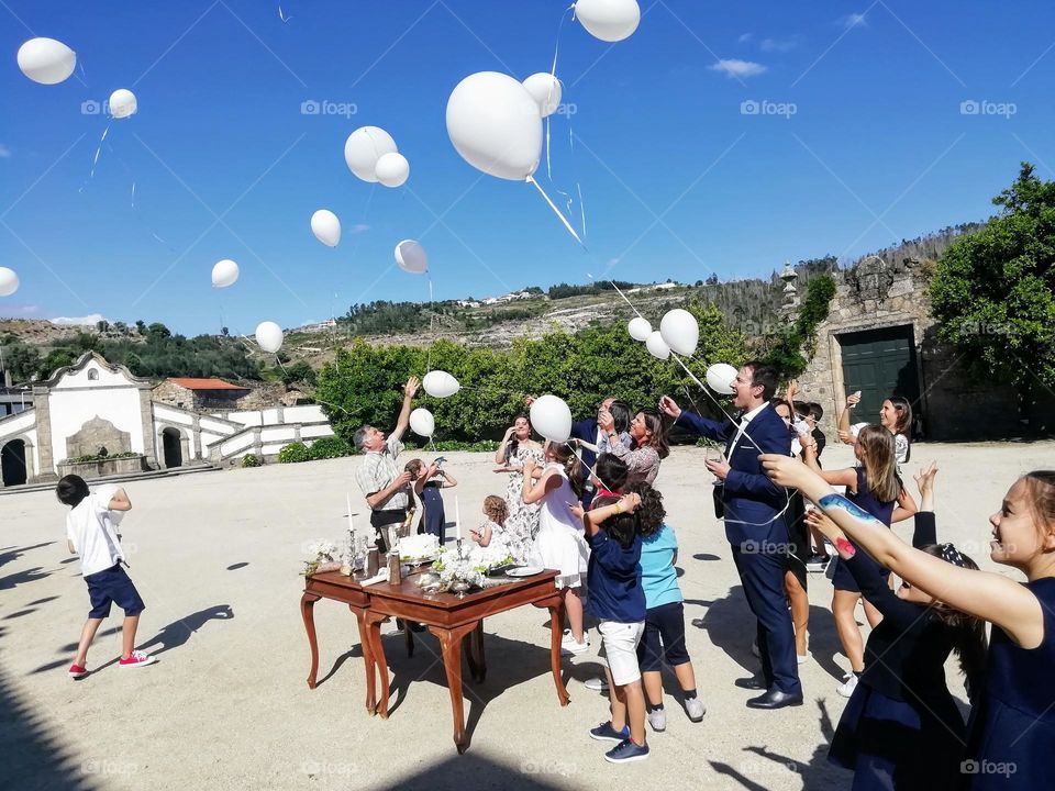 People holding helium balloons