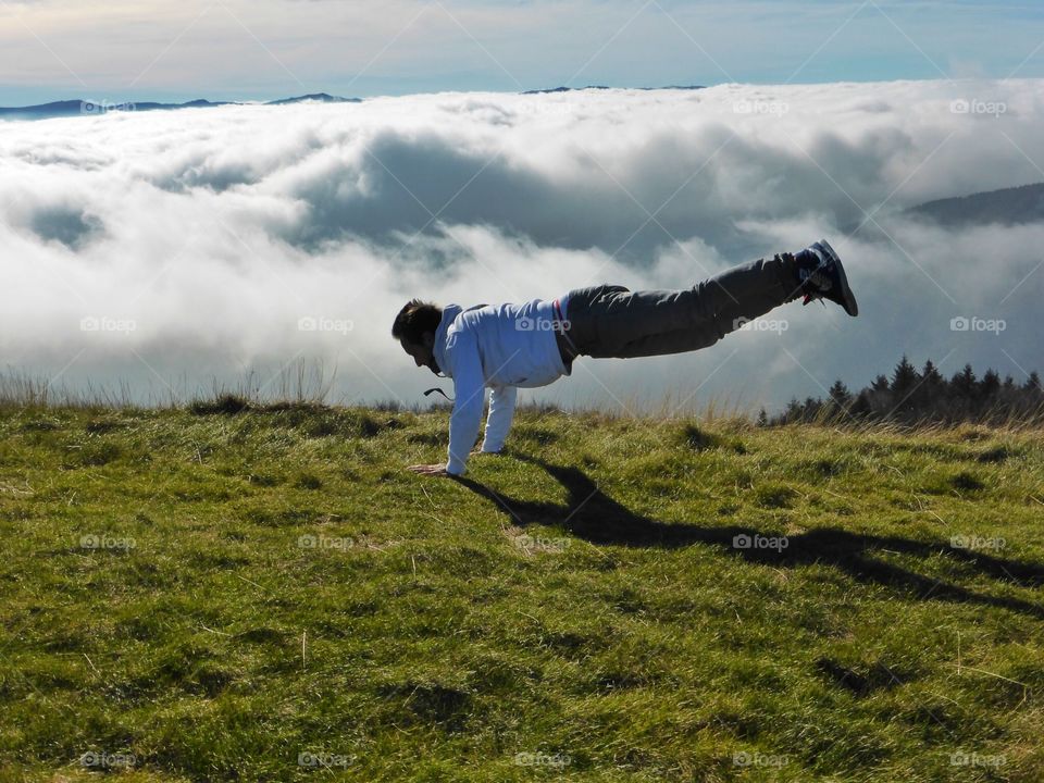 man balanced on his arms