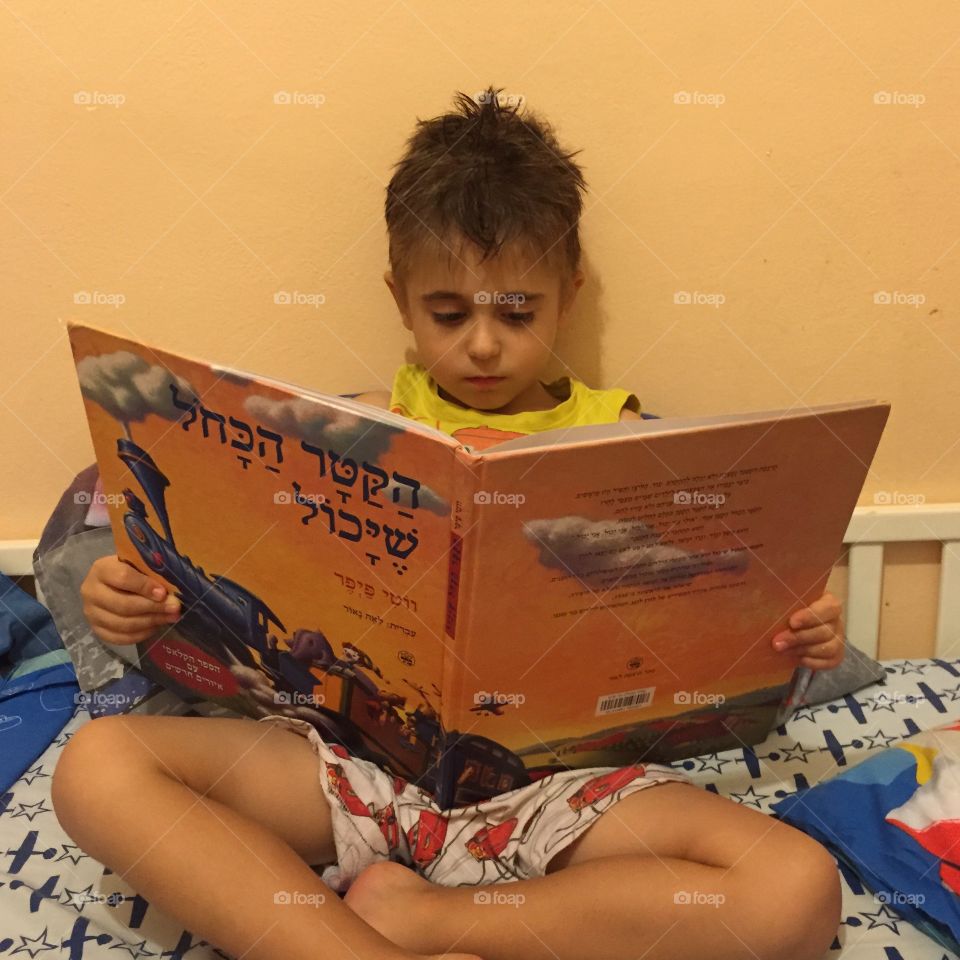 A kid reading the book 