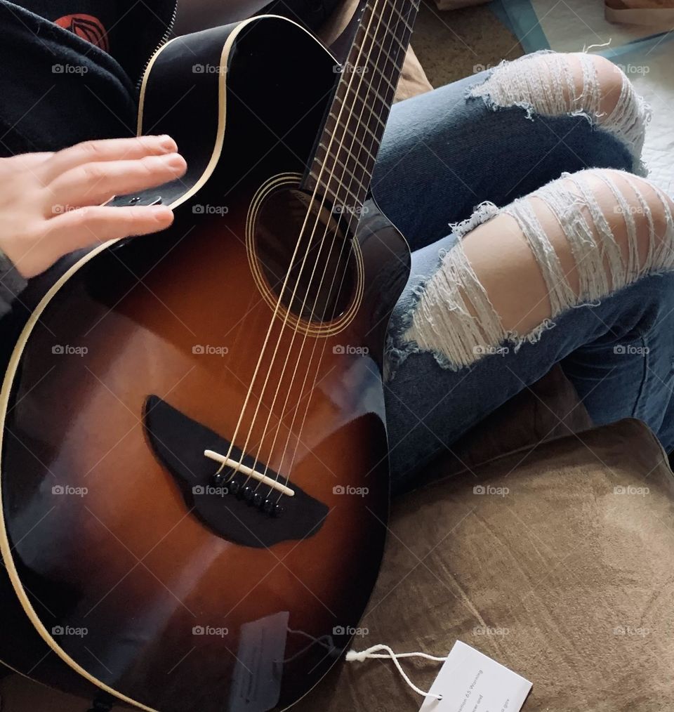 A love for music should be developed at an early age. For some, it seems to be genetic. Here’s a teen and their new guitar. 