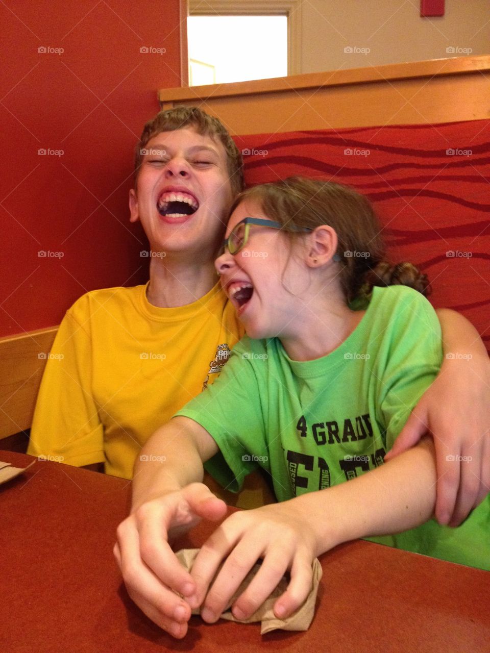 Close-up of brother and sister laughing together