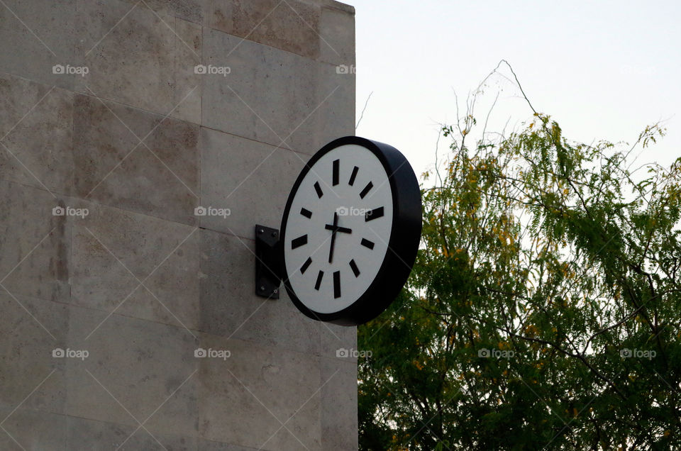Low angle view of clock on building exterior in Budapest, Hungary.