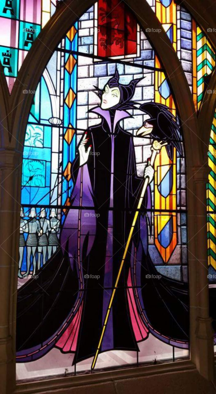 maleficent window

Disney land Paris / Euro Disneys 

one of Sleeping beauty castles 
stain glass window


(series available  )

Maleficent (/məˈlɛfɪsənt/ or /məˈlɪfɪsənt/) is the main antagonist of Walt Disney's 1959 film Sleeping Beauty. She is characterized as the "Mistress of All Evil" who, after not being invited to a christening, curses the infant Princess Aurora to "prick her finger on the spindle of a spinning wheel and die" before the sun sets on Aurora's sixteenth birthday. 

Sleeping Beauty Castle is the fairy tale structure castle at the center of Disneyland Park, Hong Kong Disneyland and Disneyland Paris. It is based on the late-19th century Neuschwanstein Castle in Bavaria, Germany,with some French inspirations (especially Notre Dame de Paris and the Hospices de Beaune).