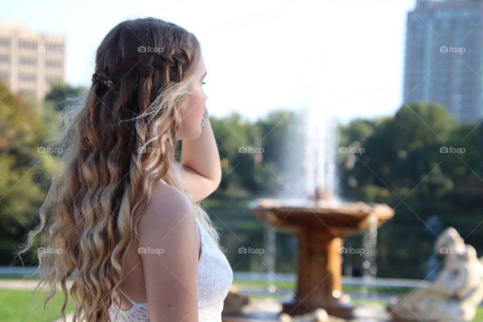 Young Beautiful female in garden with white dress