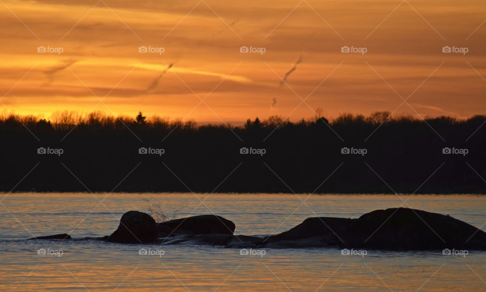 Scenic view of river against orange sky