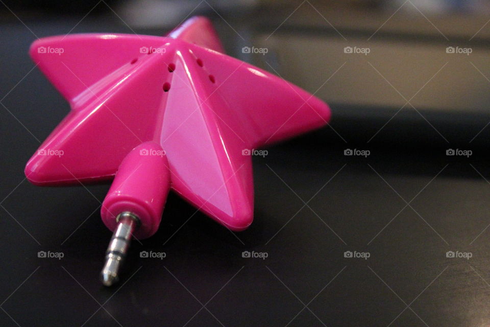 Hot pink star speaker with cell phone