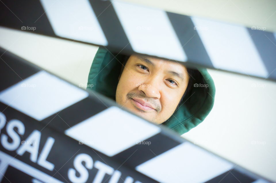 Man and clapper board for making video cinema in studio.Movie production clapper board or slate film concept.