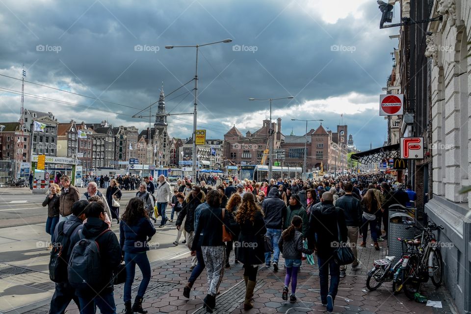 A typical day in Amsterdam, city filled with tourists sightseeing the beauty of this centre 