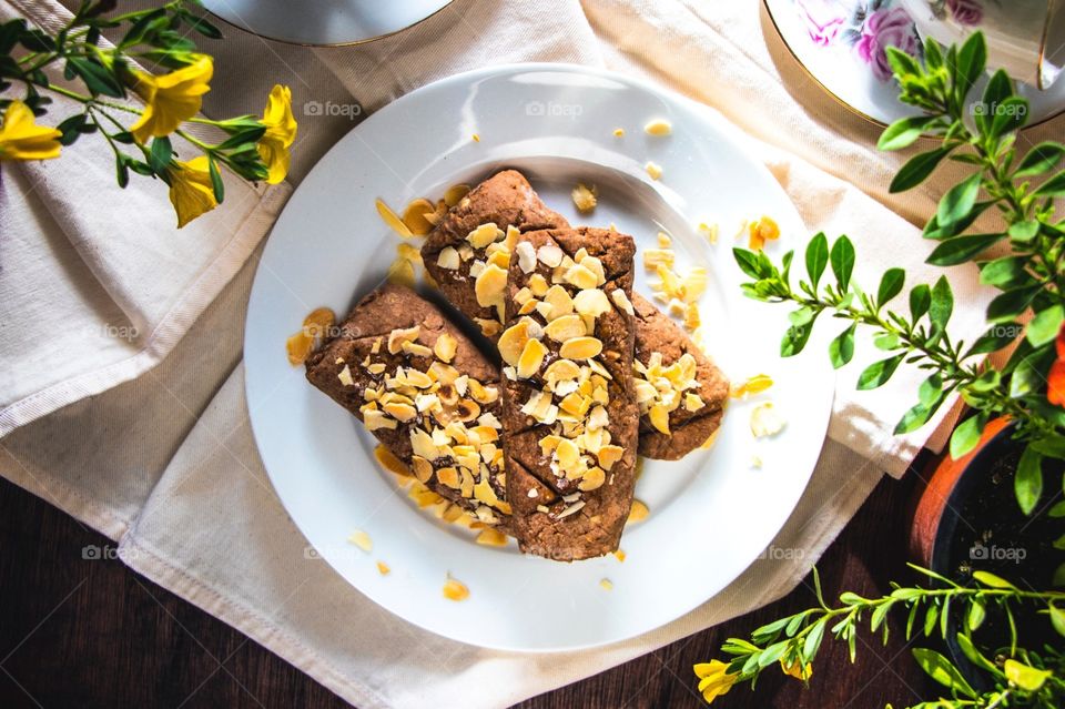 A traditional Maltese Easter biscuit known as kwarezimal. Topped with almond flakes and honey.