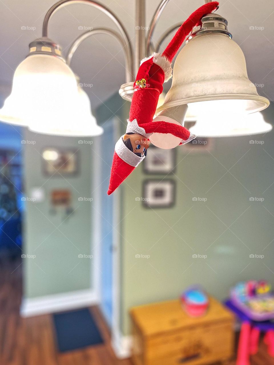 Elf on the shelf changes a light bulb, elf on the shelf hangs upside down, elf on the shelf helping with household chores, marking off the to do list, elf on the shelf antics, ideas for elf on the shelf, elf on the shelf helper 