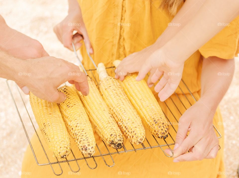 Eating grilled corn 