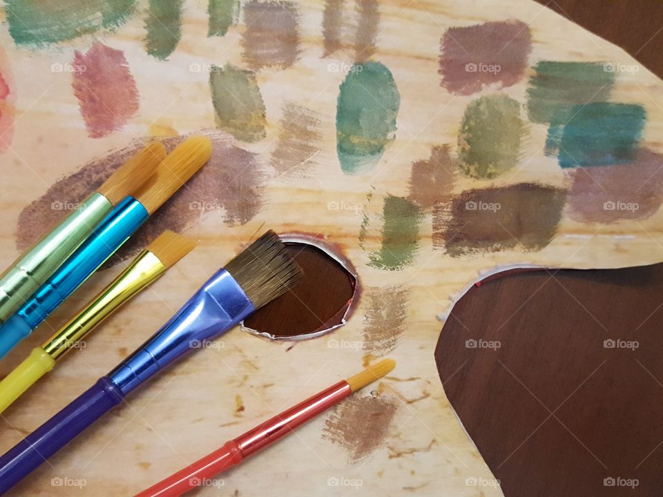 Close-up of paintbrushes on palette on table