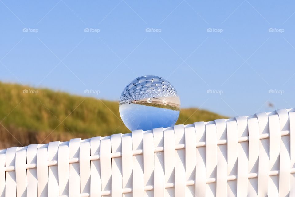 Memories of the summer. lensball on a beach chair at the Beach of sylt with the wonderful sand dunes in the background. North sea holiday 2019 