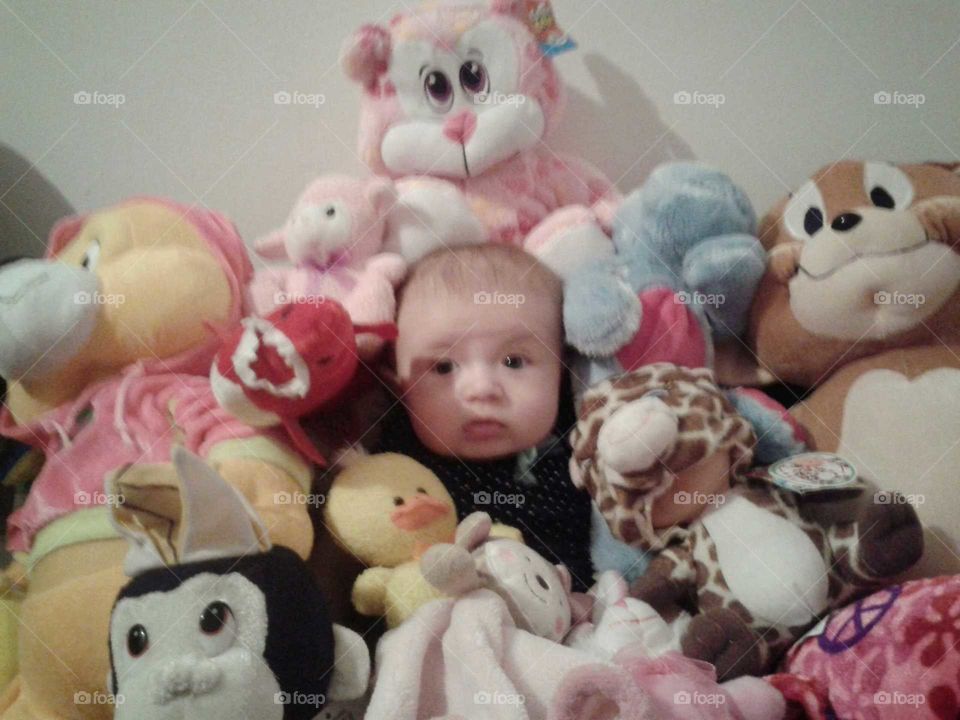 Baby boy face with soft toys