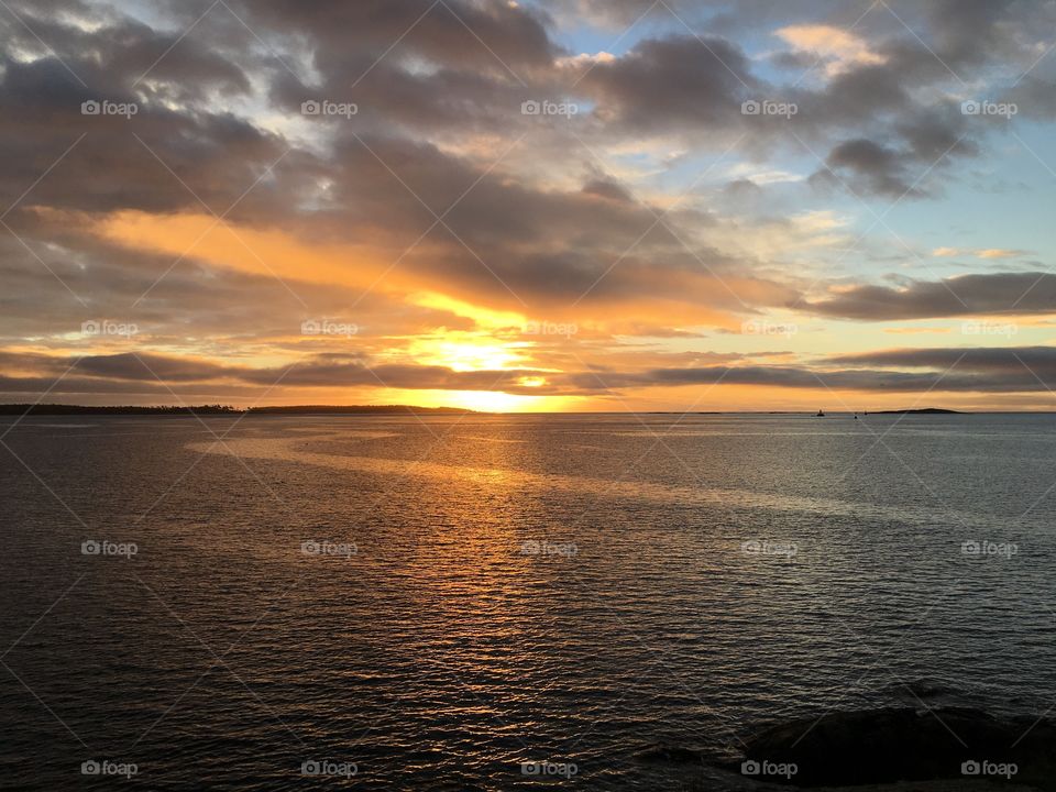 Sunlight over sea during sunset