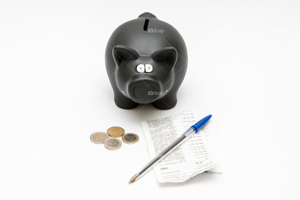 Black Piggy Bank With Coins, Pen And Sales Receipt Isolated In White Background
