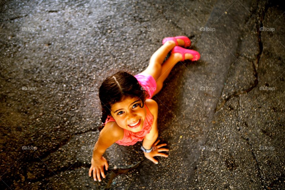 Elevated view of smiling lying on road