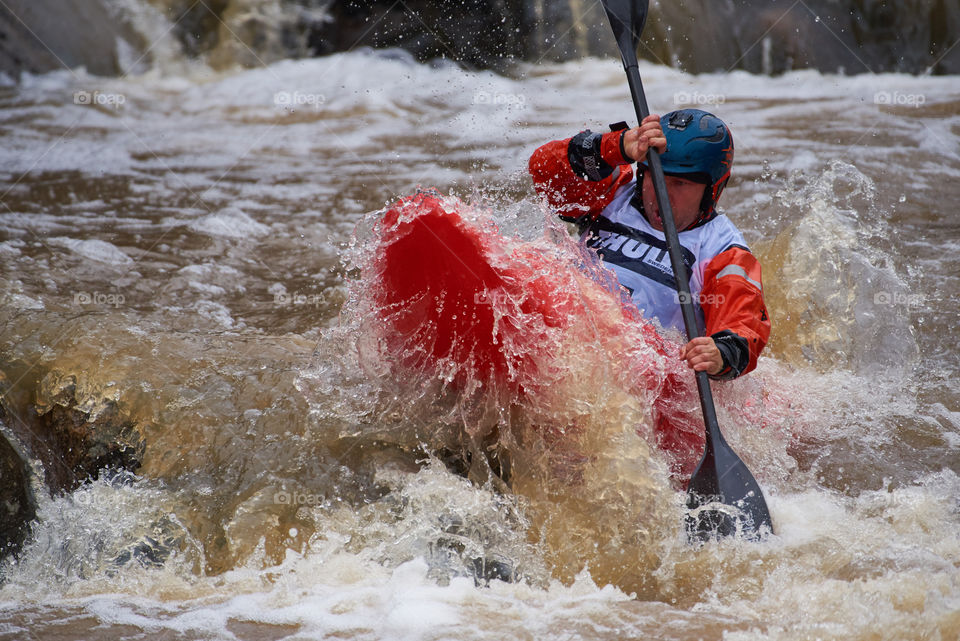 Helsinki, Finland -  April 15, 2018: Unidentified racer at the annual Icebreak 2018 whitewater kayaking competition at the Vanhankaupunginkoski rapids in Helsinki, Finland.