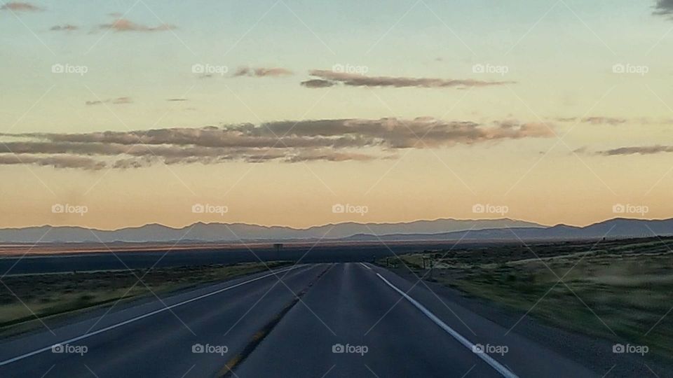rural stretch of road Highway in White Pine County Nevada USA 2017 with mountains and wide open Plains visible