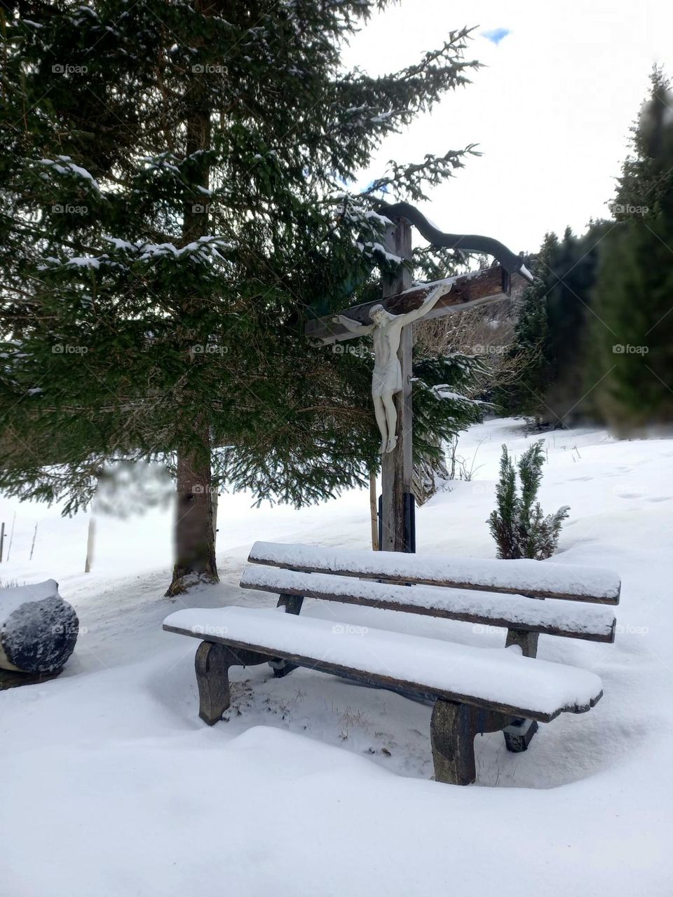 Bench and Crucifix in the Snow