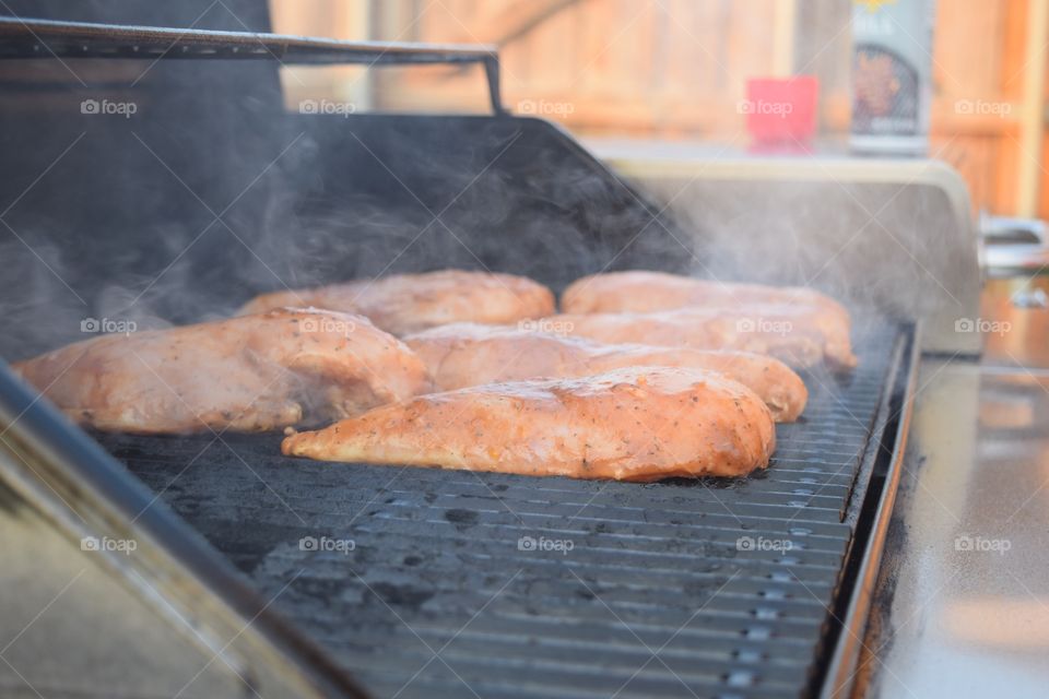 Raw chicken on the barbecue grill