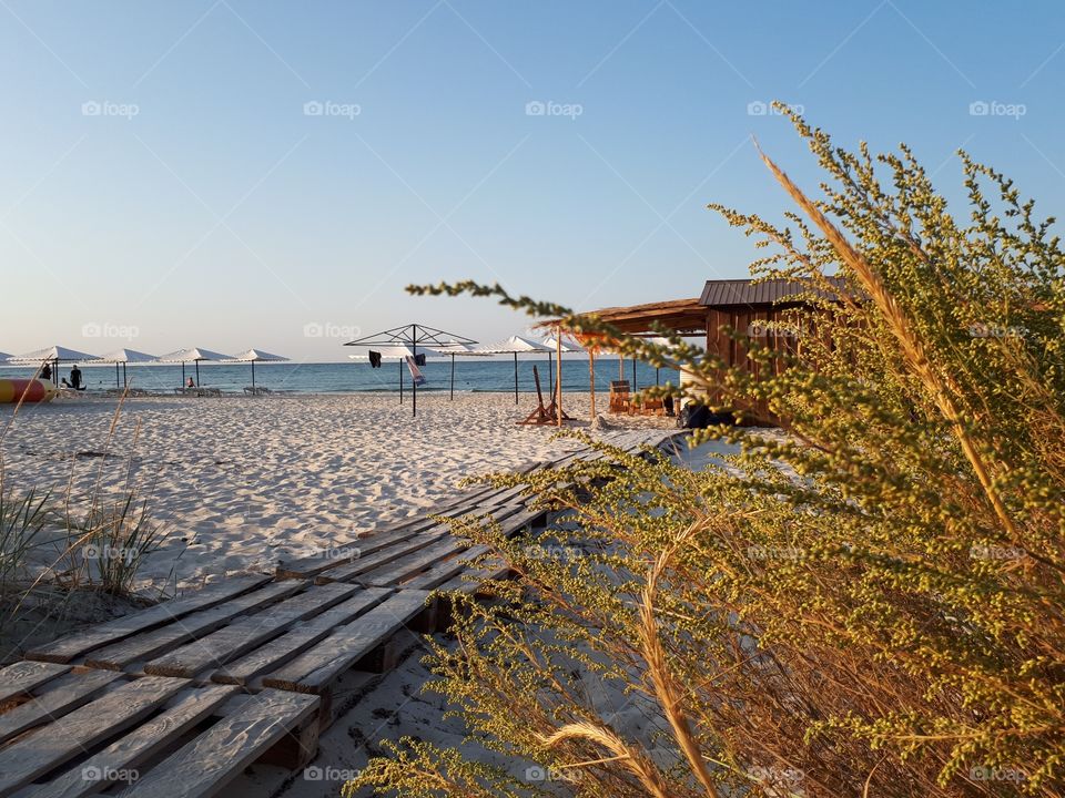 Wooden trail to the sand beach