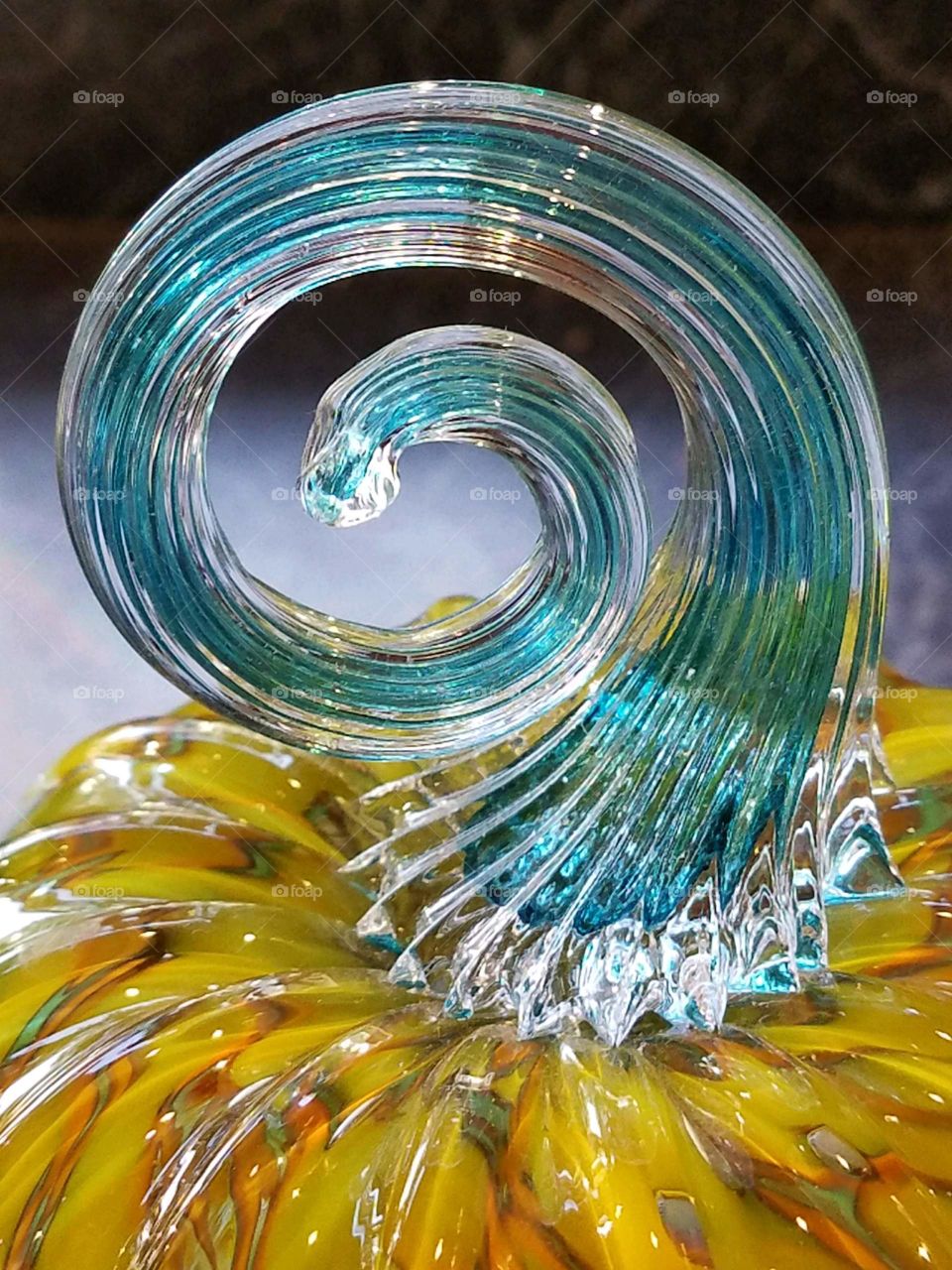 Hand blown glass pumpkin stem swirling.