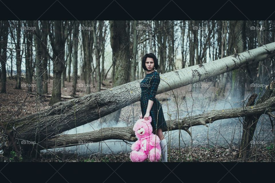 girl in a dress with a pink bear