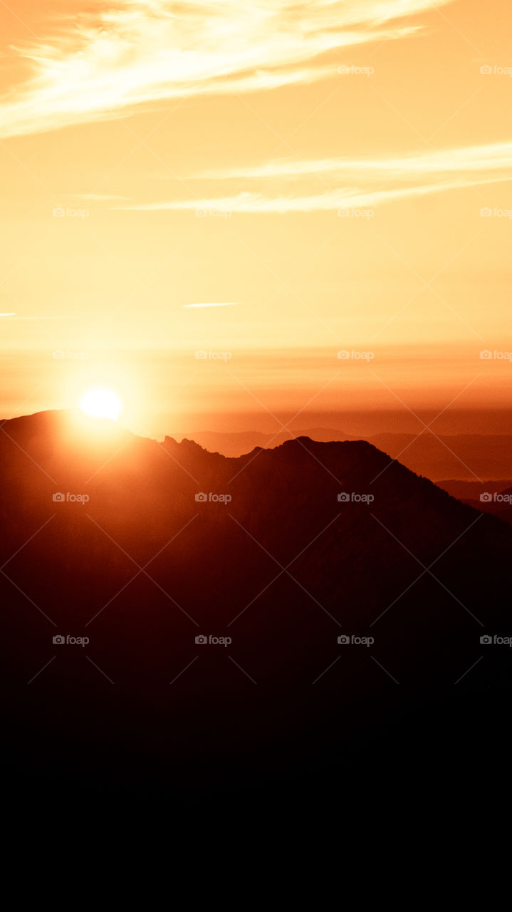 An inspiring red mountain landscape. Tatry mountains in Slovakia. A beautiful wallpaper for smartphone screen. Red abstract gradient with perspective.