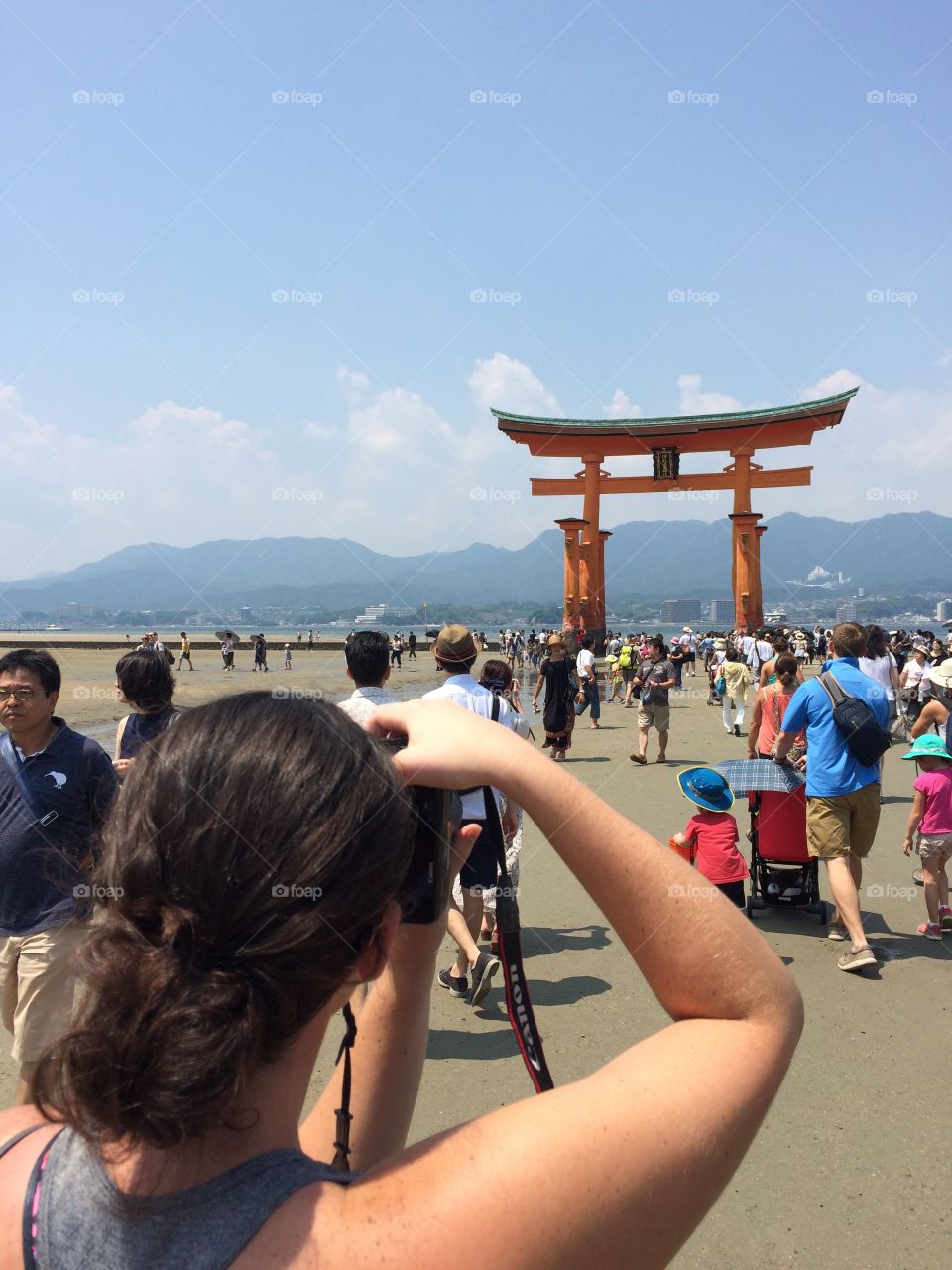 Taking pictures of floating Tori gate in Japan