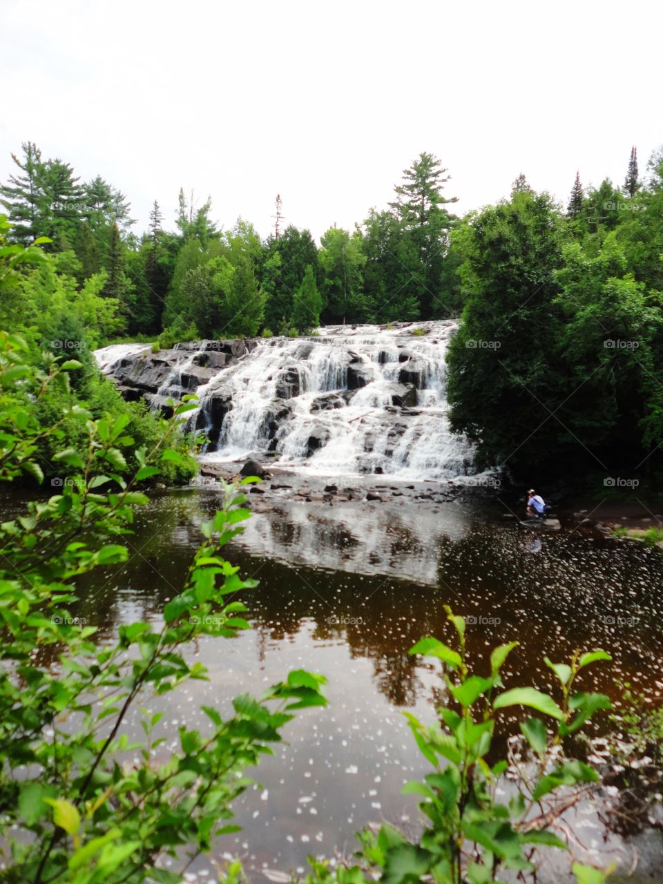 Waterfall reflected in the water. 

Bond Falls, Wisconsin