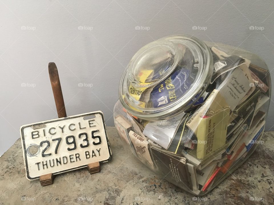 Thunder bay bicycle license plate and USA matches collection on a steel I-beam
