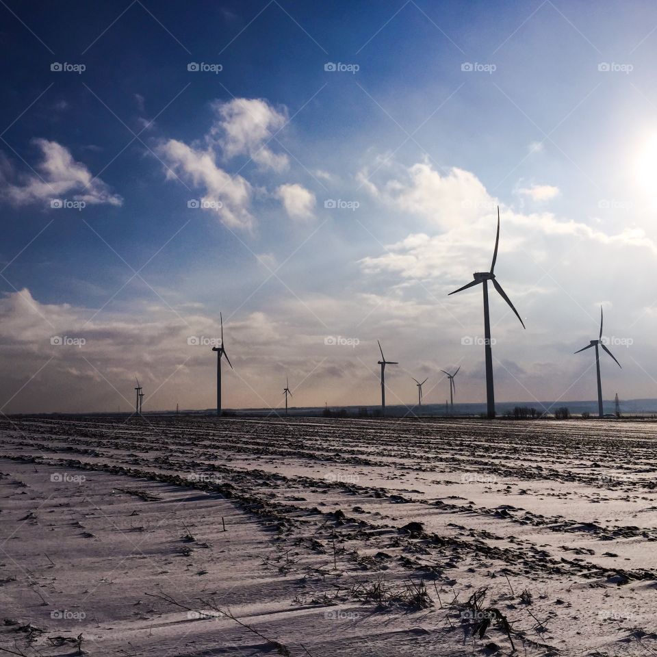 Wind turbines on snowy landscape