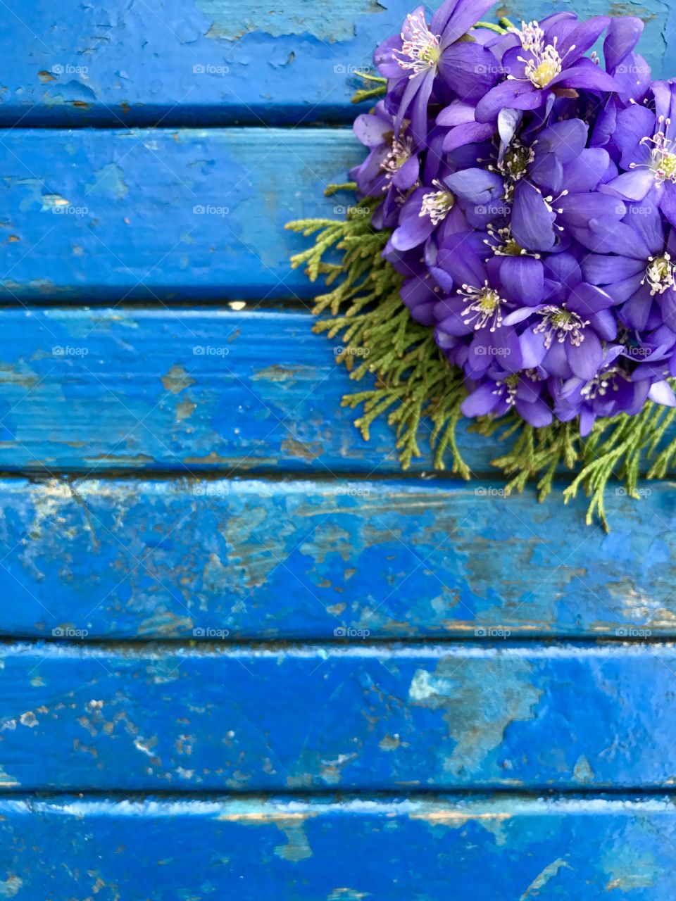 blue wooden texture and flowers on it 