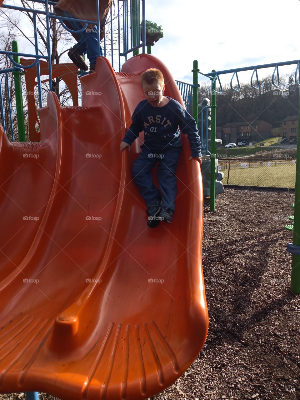 playground boy on slide