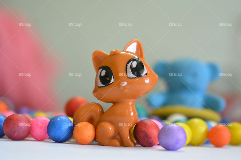 colored round balls with toys as backgrounds