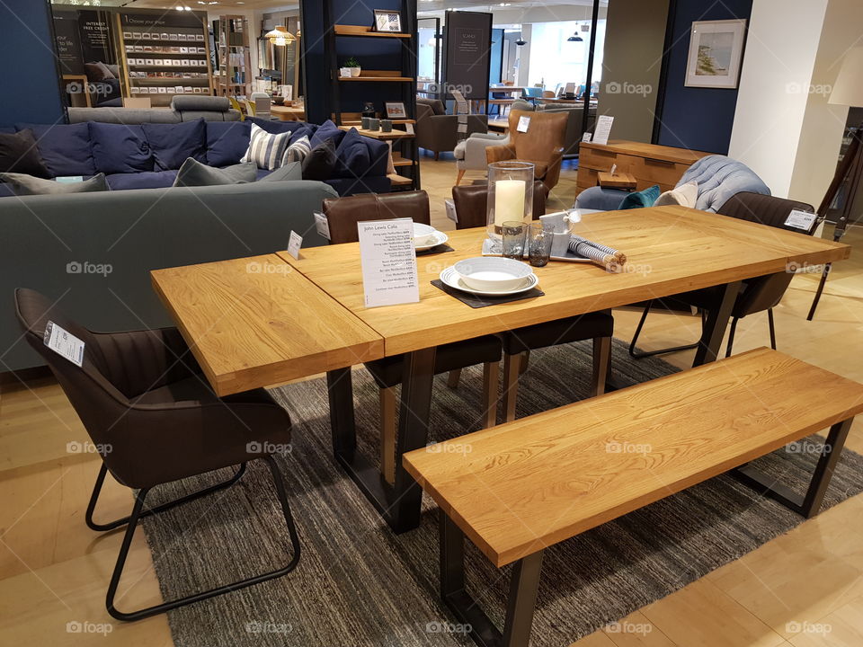 Wooden dining set with benches and rug at Peter Jones department store Sloane square Chelsea Kings road London