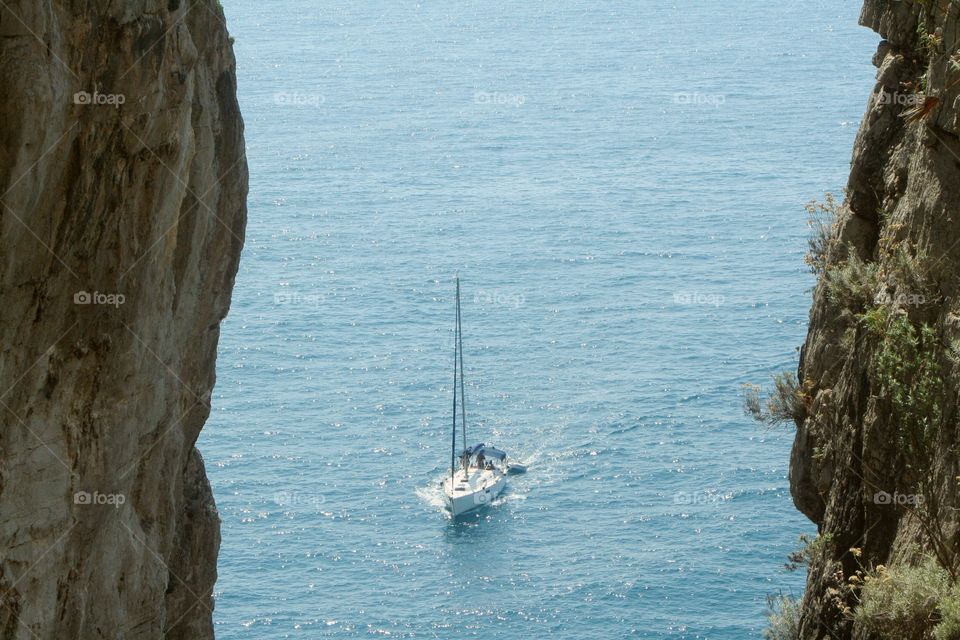 Sailboat between rock walls