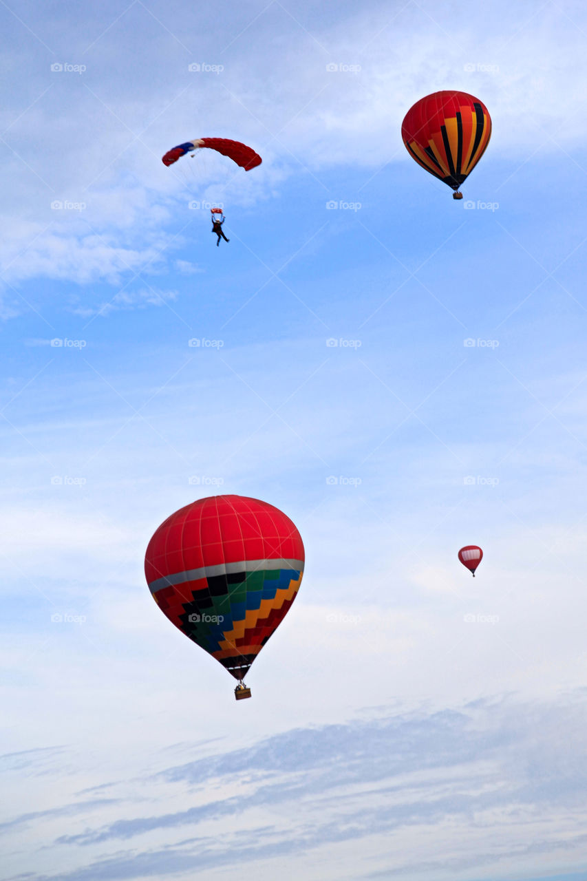 Paragliding and hotair balloon in air