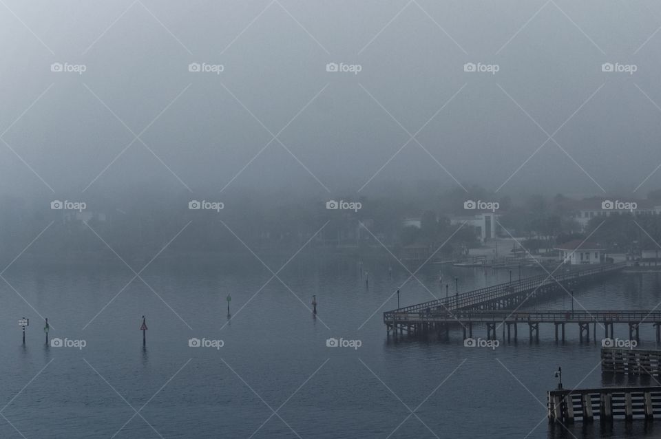 Pier in the Fog. Looking down on the Halifax River in Ormond Beach, Florida on a foggy morning. The pier is barely visible. 
