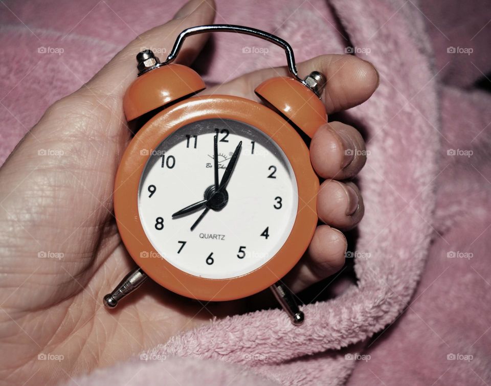 alarm clock in hand