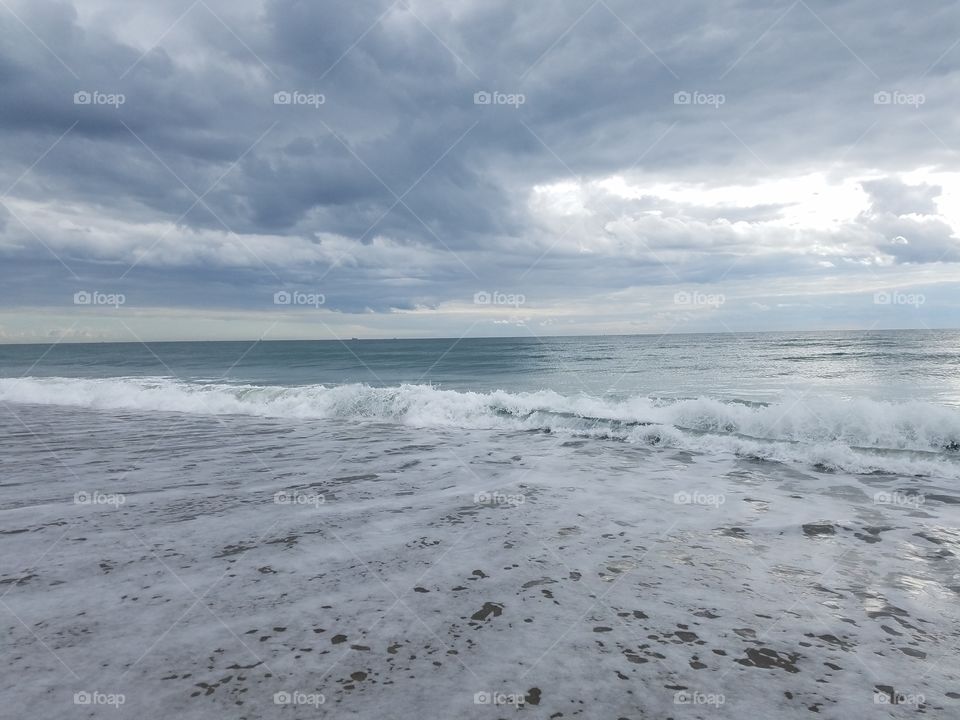 churning, turbulent surf and overcast sky
