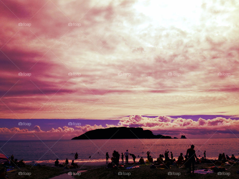 amazing sky with clouds, island, sea and beach