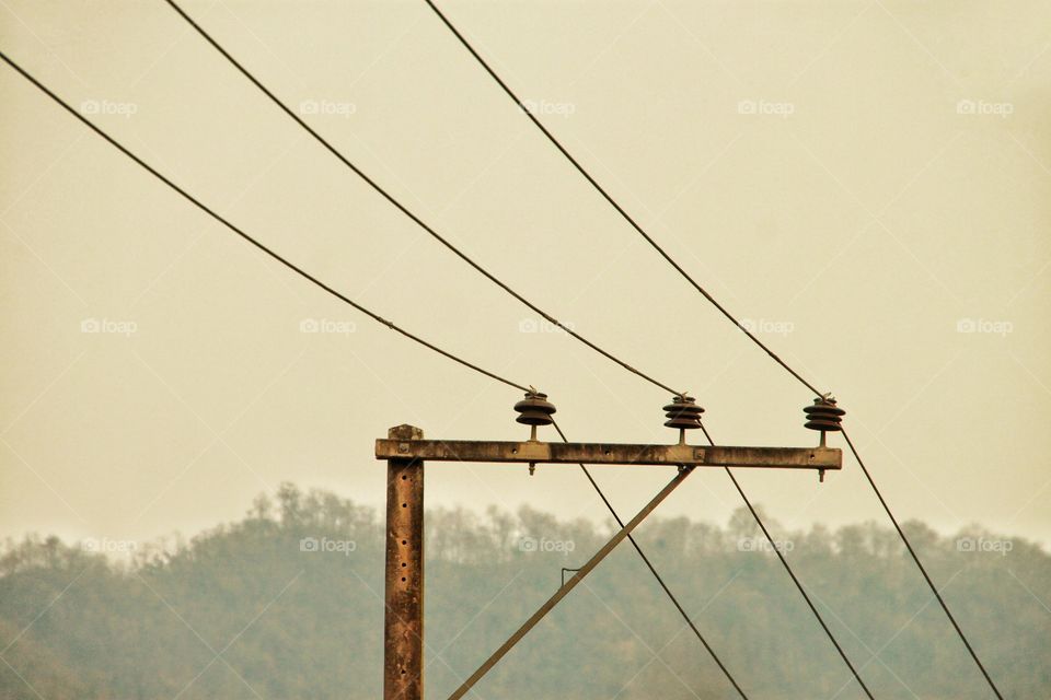 Three wires across the mountains, with a mountain view as a background.