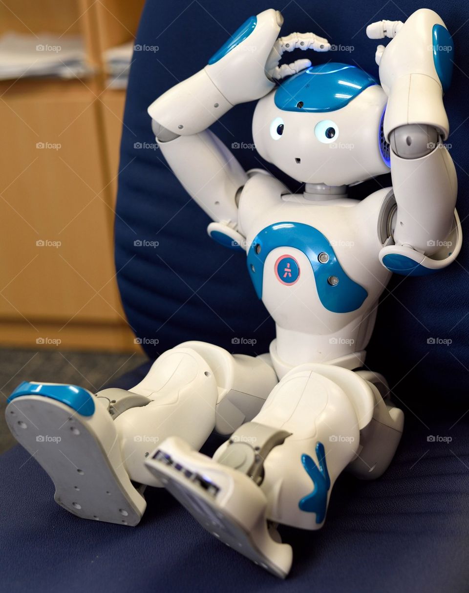 Nao robot sitting in an office chair