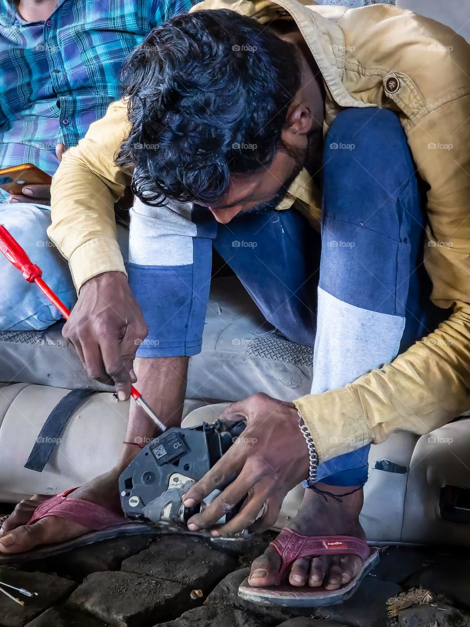 Indian mechanic opening up the door machine lock